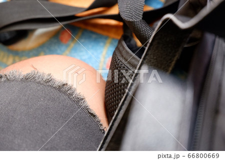 Mans leg with torn jeans, hip hop fashion style, accessories, and bag. Street fashion, backpacker, wanderer, traveller, journey, skateboarding, streetwear, aboard, transport or clothing brand concept. Mans leg with torn jeans, hip hop fashion style, accessories, and bag. Street fashion, backpacker, wanderer, traveller, journey, skateboarding, streetwear, aboard, transport or clothing brand concept. 66800669