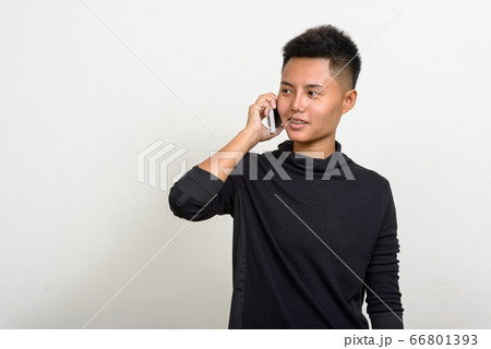 Portrait of happy young Asian lesbian woman talking on the phone Portrait of happy young Asian lesbian woman talking on the phone 66801393