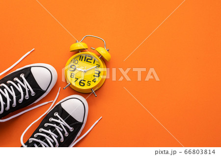 Top view new black fashion shoe and alarm clock on 66803814