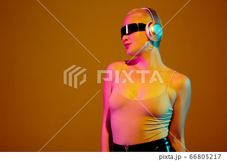 Portrait of young caucasian woman in fashionable eyewear on brown background with copyspace, unusual and freaky appearance Portrait of young caucasian woman in fashionable eyewear on brown background with copyspace, unusual and freaky appearance 66805217