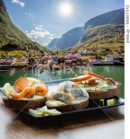 Typical Scandinavian sandwiches against typical fishing village with fjord in Norway near Flam Typical Scandinavian sandwiches against typical fishing village with fjord in Norway near Flam 66807542