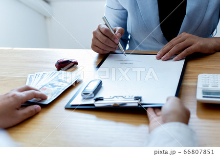 The car salesman handed the keys to the customer who passed the car purchase loan conditions ,Car rental agreement Concept. The car salesman handed the keys to the customer who passed the car purchase loan conditions ,Car rental agreement Concept. 66807851
