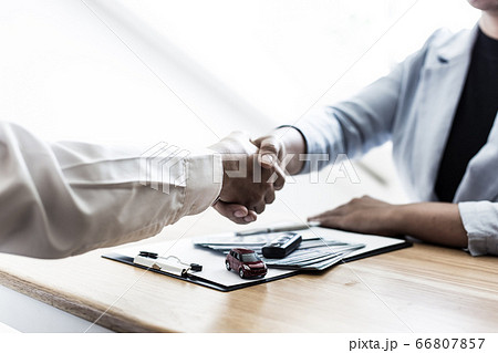 The car salesman handed the keys to the customer who passed the car purchase loan conditions ,Car rental agreement Concept. 66807857