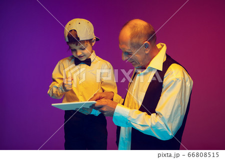 Senior man having fun and spending time together with boy, grandson. Joyful elderly lifestyle concept Senior man having fun and spending time together with boy, grandson. Joyful elderly lifestyle concept 66808515