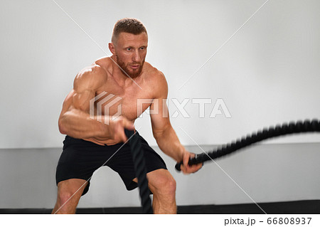 Gym battle rope man stamina training Athlete guy Gym battle rope man stamina training Athlete guy 66808937