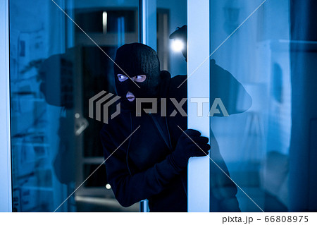 Intruder breaking into apartment or office to steal something 66808975