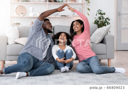 Family Insurance And Housing. Parents Making Roof Of Hands Above Little Girl 66809023