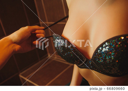 black bra being remove by a man hand. black bra being remove by a man hand. 66809660