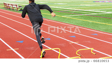 African american runner sprining over yhellow mini 66810653