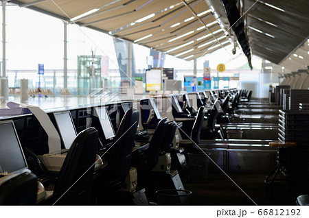 Row of empty check-in desks with computer monitors at the airport Row of empty check-in desks with computer monitors at the airport 66812192