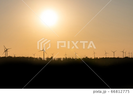 Black Silhouette of windturbines energy generator on amazing sunset at a wind farm in germany Black Silhouette of windturbines energy generator on amazing sunset at a wind farm in germany 66812775