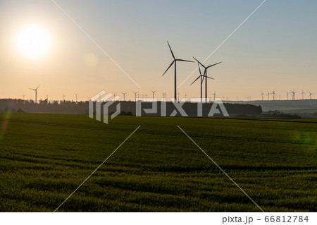 Black Silhouette of windturbines energy generator on amazing sunset at a wind farm in germany Black Silhouette of windturbines energy generator on amazing sunset at a wind farm in germany 66812784