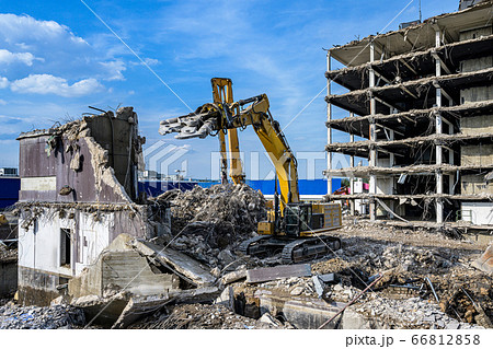 Building House Demolition site Excavator with hydraulic crasher machine and yellow container 66812858