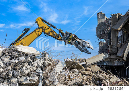Building House Demolition site Excavator with hydraulic crasher machine and yellow container 66812864