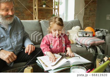 Grandfather and child playing together at home. Happiness, family, relathionship, education concept. Grandfather and child playing together at home. Happiness, family, relathionship, education concept. 66813920