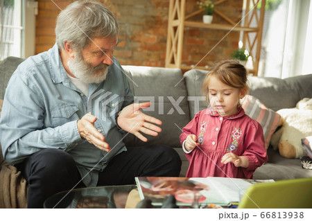 Grandfather and child playing together at home. Happiness, family, relathionship, education concept. Grandfather and child playing together at home. Happiness, family, relathionship, education concept. 66813938