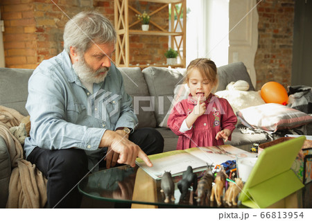 Grandfather and child playing together at home. Happiness, family, relathionship, education concept. Grandfather and child playing together at home. Happiness, family, relathionship, education concept. 66813954