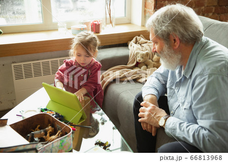 Grandfather and child playing together at home. Happiness, family, relathionship, education concept. Grandfather and child playing together at home. Happiness, family, relathionship, education concept. 66813968