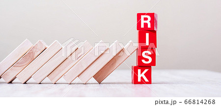 Red RISK cube blocks stop falling blocks on table. Red RISK cube blocks stop falling blocks on table. 66814268