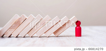 Red wooden Man stop falling blocks on table. fall 66814270