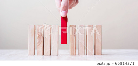 Businessman hand placing or pulling Red wooden 66814271