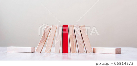 Red block and wooden blocks stand on table. Red block and wooden blocks stand on table. 66814272