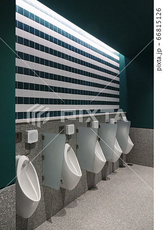 Urinals in a stylish toilet with dark green walls Urinals in a stylish toilet with dark green walls 66815126