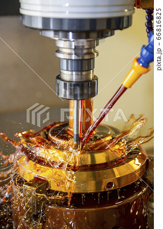 The CNC milling machine cutting the brass parts. 66816825