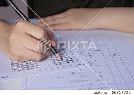 Students hand holding pencil writing selected 66817739