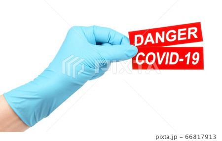 Woman hand in medical gloves holds red sign Danger Woman hand in medical gloves holds red sign Danger 66817913