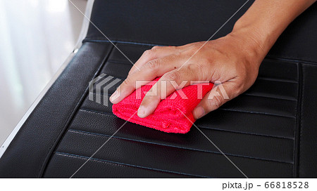 Using red cloth to wipe on chair to clean and Using red cloth to wipe on chair to clean and 66818528