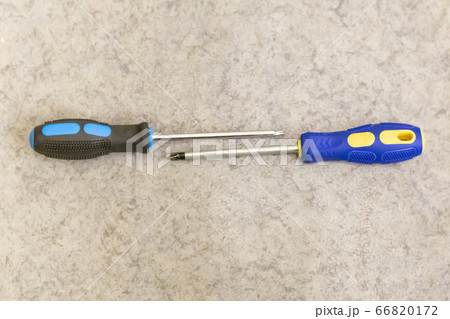 two screwdrivers on a light background lie two screwdrivers on a light background lie 66820172