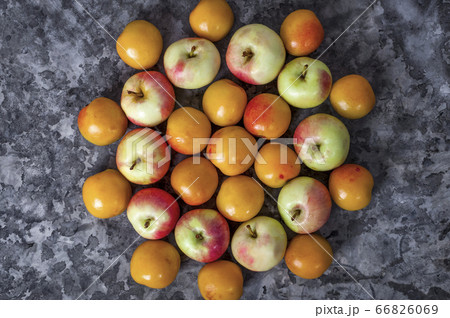 Fruit season. Ripe apples and apricot lying on the 66826069