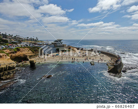 Beachgoers enjoying a beautiful sunny afternoon at La Jolla Cove 66826407