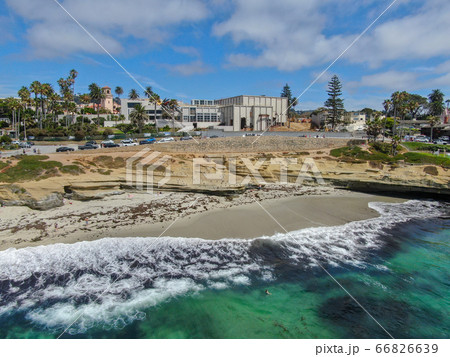 Beachgoers enjoying a beautiful sunny afternoon at La Jolla Cove 66826639