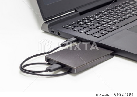 black external hard drive connect to laptop computer isolated white background  66827194