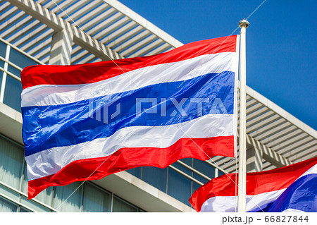 Thai flag with a commercial building background. Thai flag with a commercial building background. 66827844