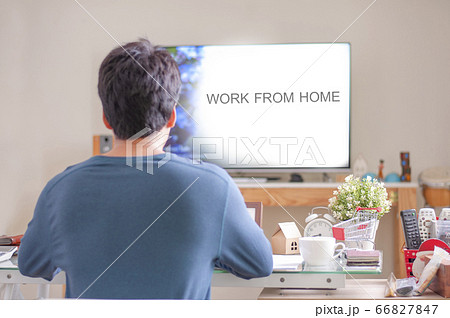 Man wear blue shirt sitting in Living room for work at home. Man wear blue shirt sitting in Living room for work at home. 66827847