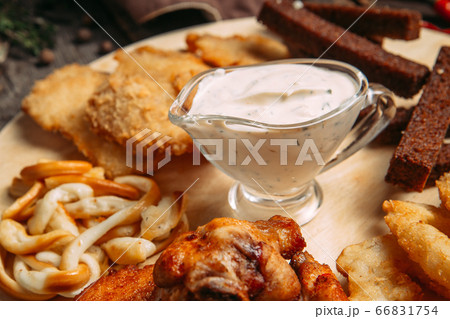 Closeup on beer snacks set on the wooden board 66831754