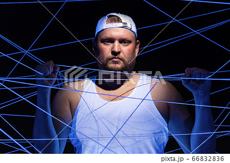 Portrait of stout man with white threads in neon light 66832836