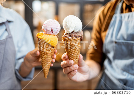Cheering with yummy ice creams indoors Cheering with yummy ice creams indoors 66833710