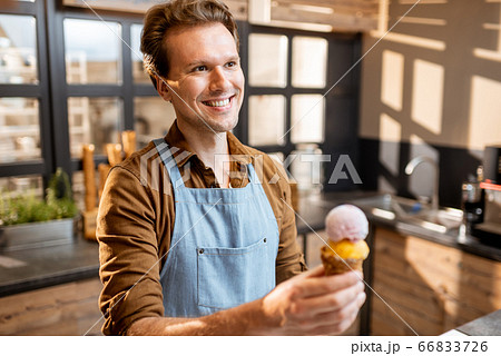 Portrait of an ice cream seller in the shop Portrait of an ice cream seller in the shop 66833726