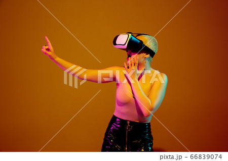 Portrait of young caucasian woman in fashionable eyewear on brown background with copyspace, unusual and freaky appearance Portrait of young caucasian woman in fashionable eyewear on brown background with copyspace, unusual and freaky appearance 66839074