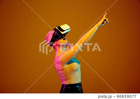 Portrait of young caucasian woman in fashionable eyewear on brown background with copyspace, unusual and freaky appearance Portrait of young caucasian woman in fashionable eyewear on brown background with copyspace, unusual and freaky appearance 66839077