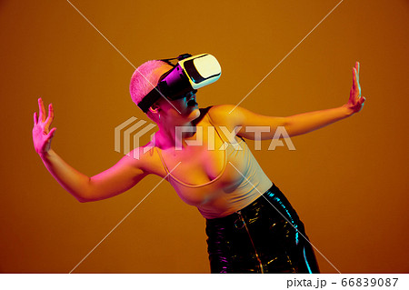 Portrait of young caucasian woman in fashionable eyewear on brown background with copyspace, unusual and freaky appearance Portrait of young caucasian woman in fashionable eyewear on brown background with copyspace, unusual and freaky appearance 66839087