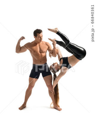 Strong man doing acrobatics with beauty girl 66840361