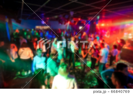 blurred silhouettes of people dancing in a nightclub 66840769