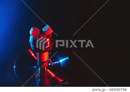 red hot coals of a shisha in a hookah bowl on a black background red hot coals of a shisha in a hookah bowl on a black background 66840796