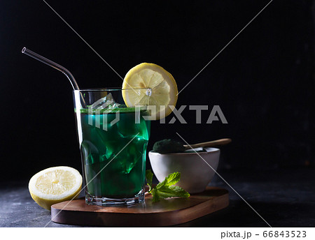 Green drink prepared with single celled green algae chlorella. Detox superfood in the glass. Dark and moody Green drink prepared with single celled green algae chlorella. Detox superfood in the glass. Dark and moody 66843523