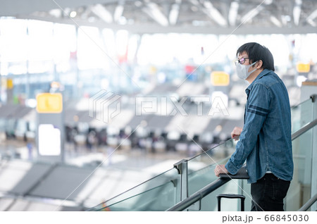 Asian man tourist wearing mask in airport terminal 66845030